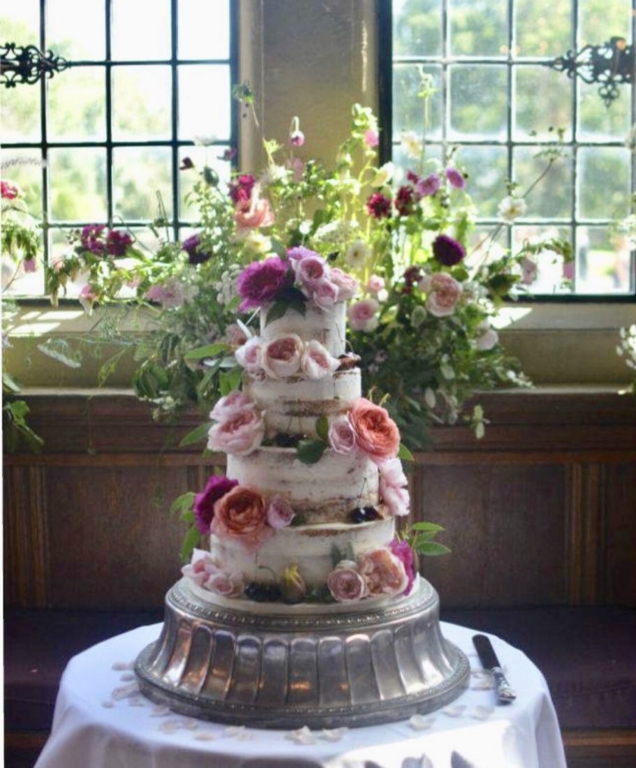 Beautiful semi-naked wedding cake at Rhinefield House. English flowers by Jenni Bloom