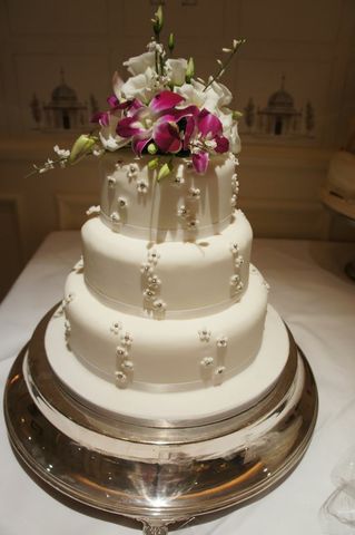 Pretty wedding cake with fresh flower topper