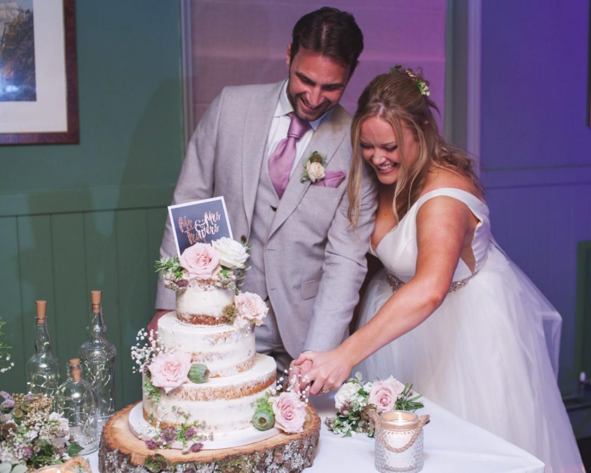 Lovely couple cutting their cake.