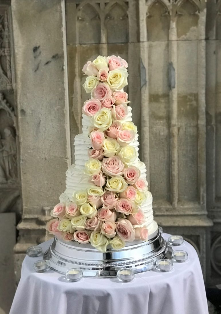 Beautiful cascading roses wedding cake at Highcliffe Castle. Buttercream iced. Flowers by Jules florist.