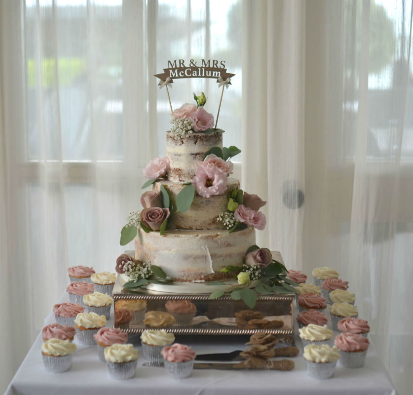 Semi-naked wedding cake with cupcakes. Flowers by Flowers by Design at Christchurch Harbour Hotel