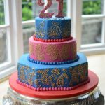 Hand piped paisley & gold design large birthday cake.
