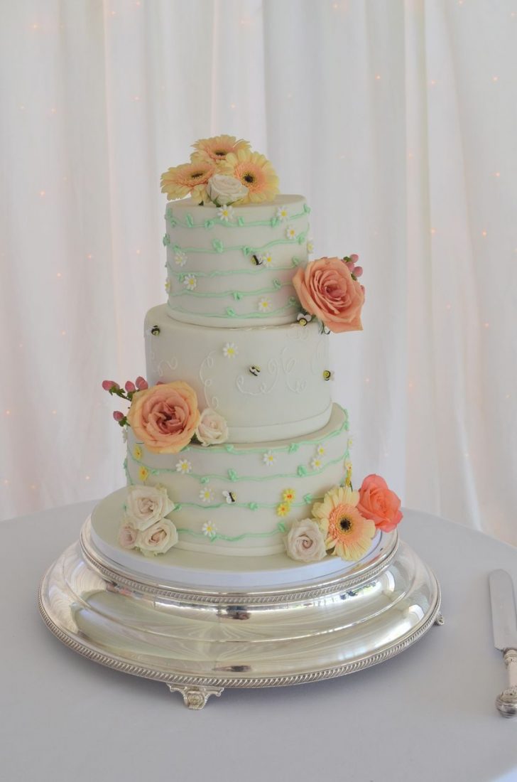 Bumblebee/wasp vine wedding cake. Flavours were Toffee apple & cinnamon, Bumble bee yellow & black striped, Passion fruit & white chocolate. Flowers by Simply flower